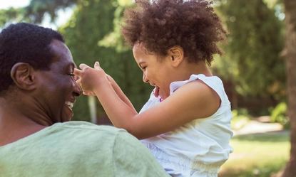 happy-family-sweet-curly-kid-sitting-playing-with-her-dad-feeling-happy