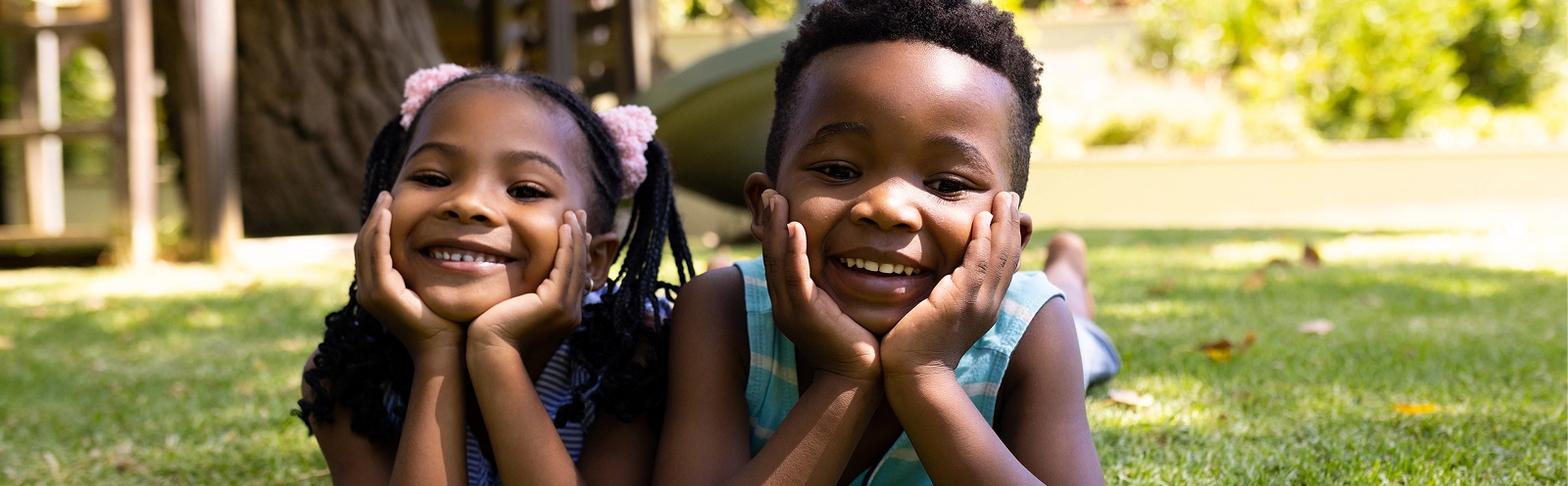 portrait-cute-african-american-siblings-with-hands-chins-lying-grassy-field-park